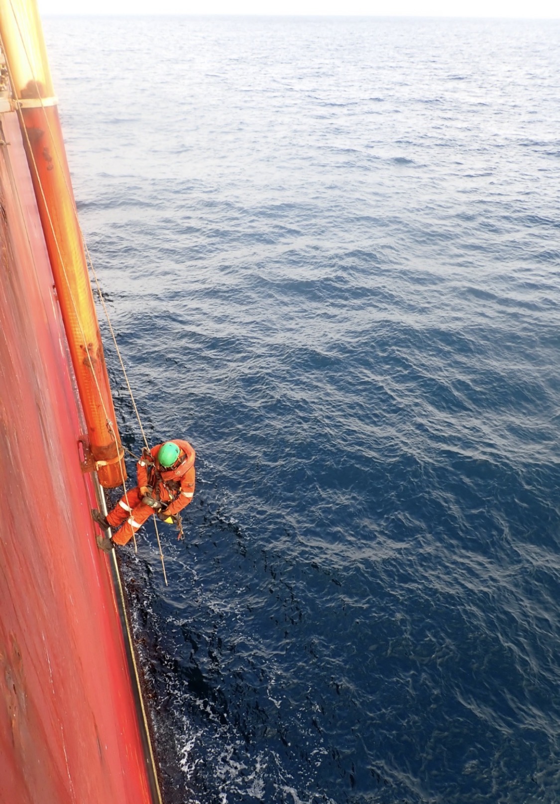 Rope access technician working over water on an FPSO
